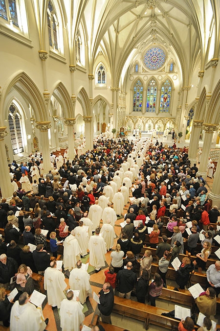 Area priests process into St. Joseph Cathedral to begin the Chrism Mass. Bishop Richard J. Malone blessed the Holy Oil which is distributed to area churches. (Dan Cappellazzo/Staff Photographer)